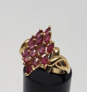 Gold ring with clustered pink gemstones.