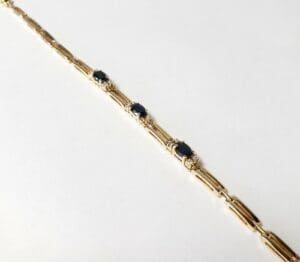 Gold bracelet with blue gemstones and diamonds.