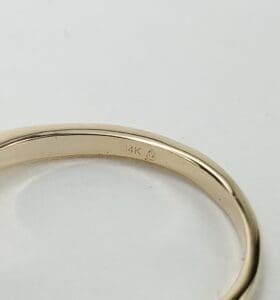 14K gold ring on white background.