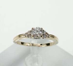 Gold ring with three diamond stones.