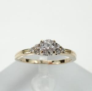 Gold ring with clustered diamond setting.