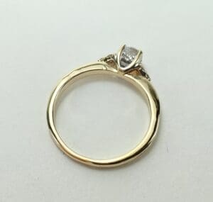 Gold ring with a diamond on top.