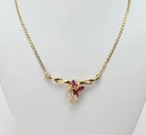 Gold necklace with ruby and diamond accents.