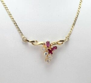 Gold necklace with ruby and diamond pendant.
