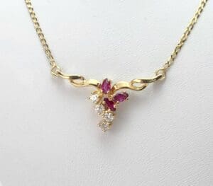 Gold necklace with ruby and diamond pendant.