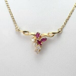 Gold necklace with ruby and diamond pendant.