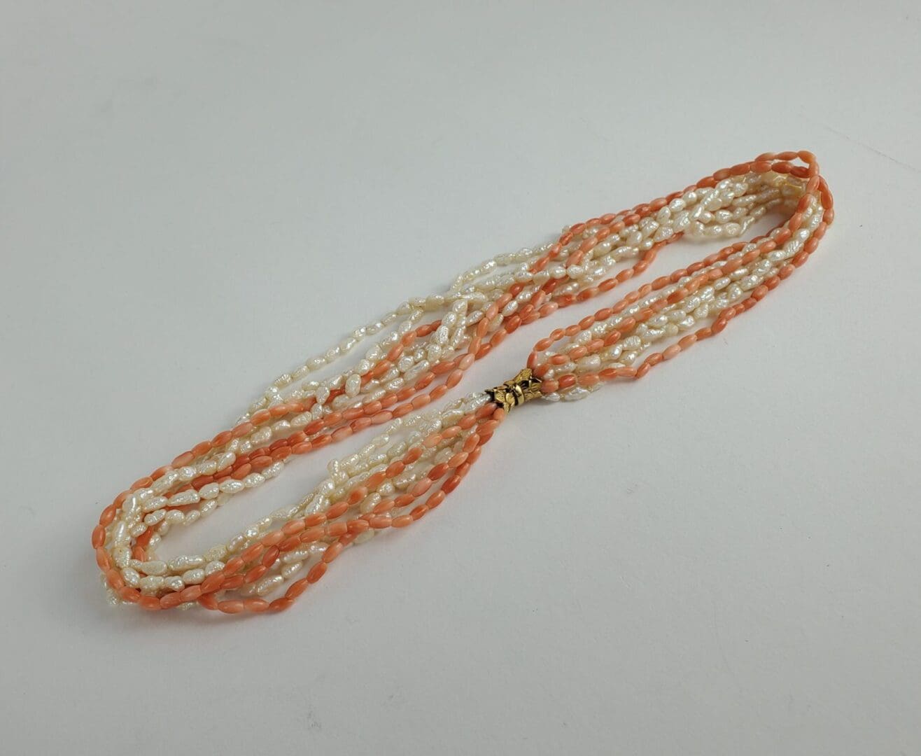 Orange and white beaded necklace on display.