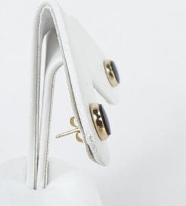 Gold and black stud earrings on display.
