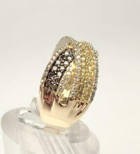 Gold ring with multicolored gemstones on display.