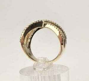 Gold ring with decorative textured edge.