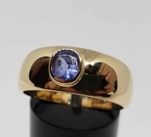 Gold ring with a blue gemstone.