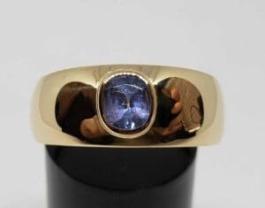 Gold ring with a blue gemstone.