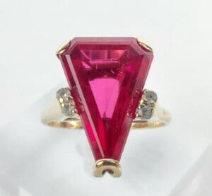 Gold ring with large red gemstone.