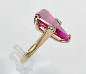 Gold ring with large pink gemstone.