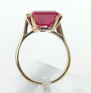Gold ring with a large red gemstone.