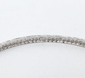 Silver bracelet with engraved detailing inside.