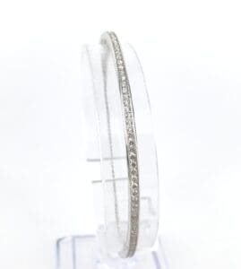 Silver bangle with small diamond accents.