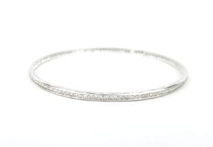Silver diamond bangle on white background.