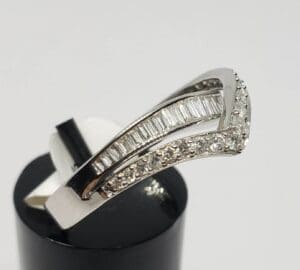 Silver ring with embedded diamonds on display.