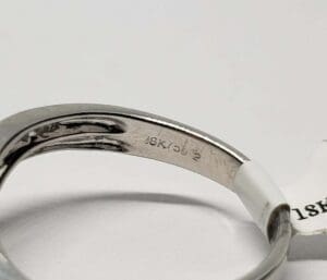 Engraved silver ring with "18K 562" marking.