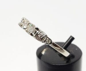 Silver ring with multiple small diamonds.