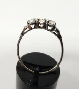 Silver ring with heart-shaped cutouts and stones.