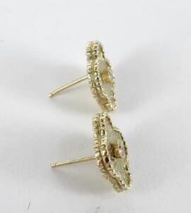 Gold stud earrings with textured edges.