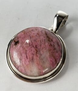 Pink gemstone pendant with silver setting.