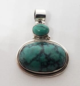 Silver pendant with turquoise stones.