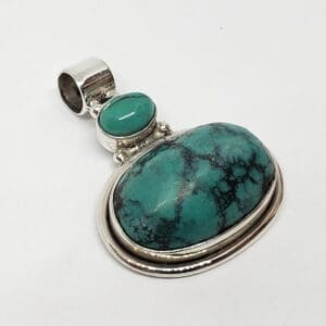 Silver pendant with turquoise stones.