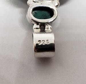 Silver pendant with green stone, "925" marking.