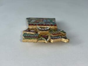 Gold pendant with colorful enamel and stones.