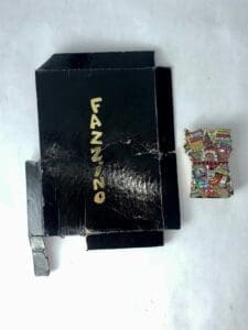 Black box with colorful magnet beside it.