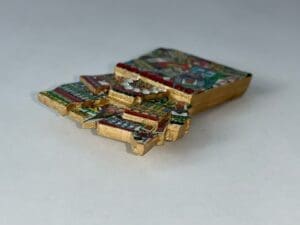 Colorful mosaic brooch with intricate patterns.