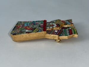 Colorful, intricately designed gold-bordered decorative item.