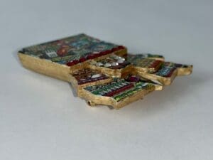 Ornate golden mosaic key with colorful patterns.