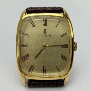 Gold watch with Roman numeral dial.