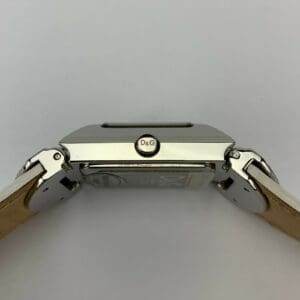 Silver watch with tan leather straps.