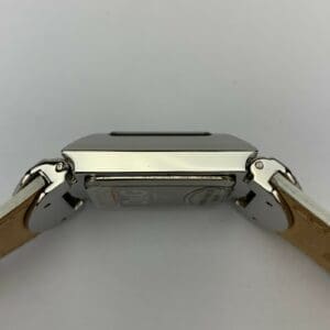 Smartwatch with leather strap, side view.