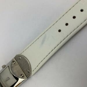 White leather watch strap with buckle.