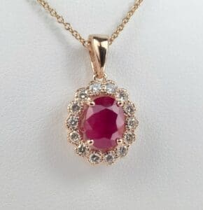 Gold necklace with ruby and diamond pendant.