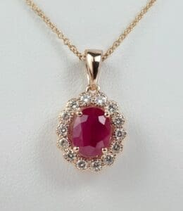 Gold necklace with ruby and diamonds pendant.