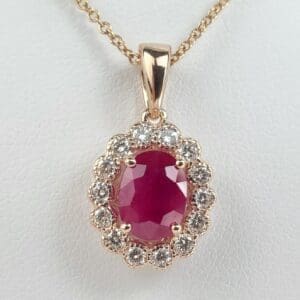 Gold necklace with ruby and diamonds pendant.