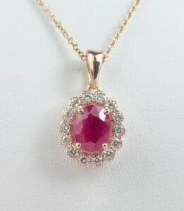 Gold necklace with ruby and diamond pendant.