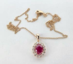 Gold necklace with ruby and diamond pendant.