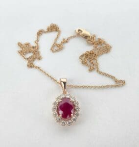 Gold necklace with ruby and diamond pendant.