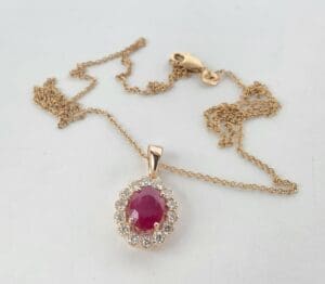 Gold chain with ruby and diamond pendant.