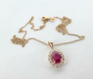 Gold necklace with ruby and diamond pendant.