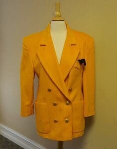 Yellow double-breasted blazer on mannequin.
