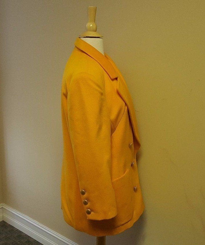 Yellow blazer on mannequin, side view.